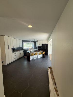 Modern kitchen update with fresh paint, sleek cabinetry, bold tile floors, and a bright, inviting island space.