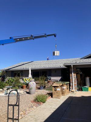 The crane getting rid of existing swamp cooler.