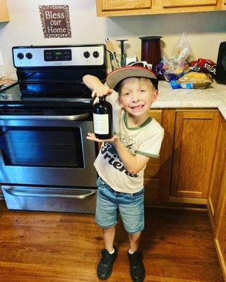 My son holding some Super Herbal Elderberry Tonic 
It taste  like cinnamon vanilla, and it Prevents and fights sickness , and stomach
