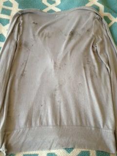 My sweater with black stains all over it after Columbus Cleaners "cleaned" it. Buyer beware!