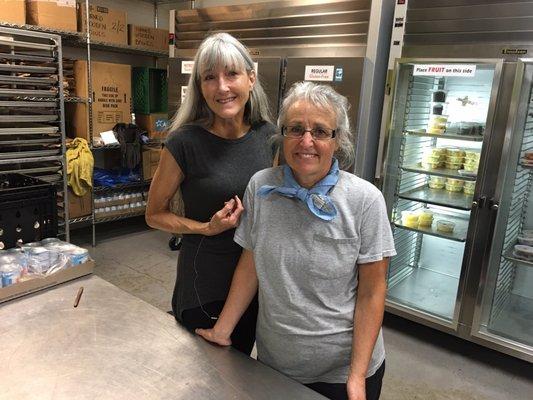 Tana & Cindy filling bags with food & love