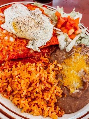 Red, ground beef enchiladas with a requested egg on top, served with rice and beans. They have cheese, beef and chicken options also.