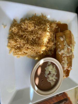 Combination dinner of 2 chicken enchiladas, rice, and beans