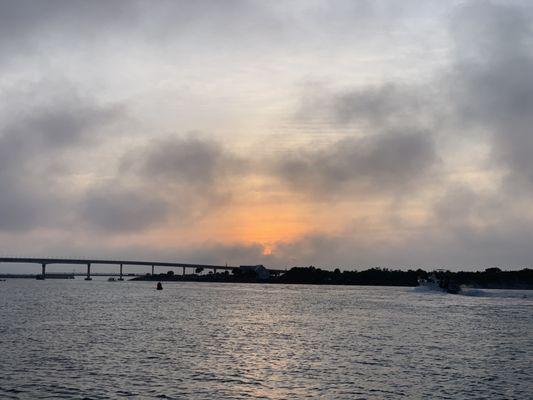 Sunrise heading to the ocean through Sebastian Inlet