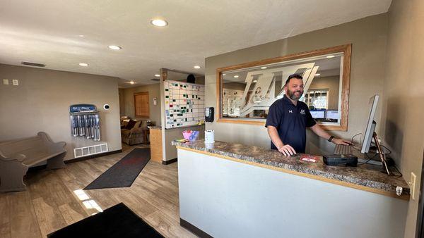 Justin greeting customers with a smile.