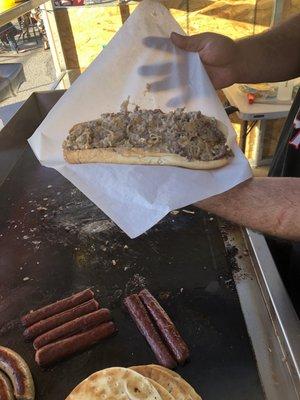 Foot long Philly cheesesteak. Thinly sliced ribeye, sharp white cheddar and grilled onions.