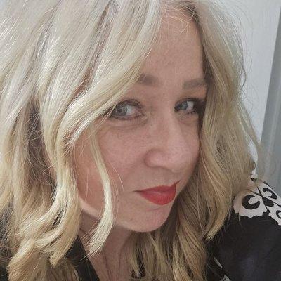 Blonde bob, lightly layered with loose curls.