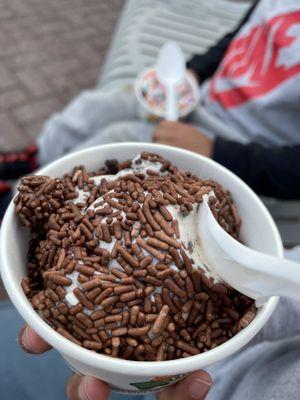 Chocolate sprinkles over cookies and cream kids cup.