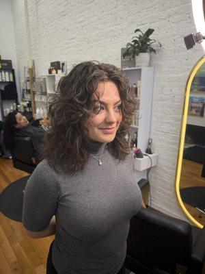 A razor layered haircut! Enhancing her natural curls.