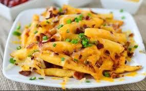 Azada fríes French fries,azada beef, cheddar cheese, nacho cheese, onion and jalapeño