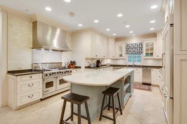 Beautiful white kitchen with contrasting blue Island