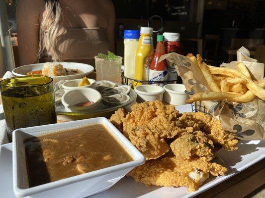 Oyster & Fish platter comes with 2 sides (Chicken & Sausage Gumbo and French Fries), half a dozen Raw Oysters, and Crawfish Étouffée