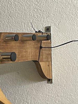 Coat rack held up with zip ties.