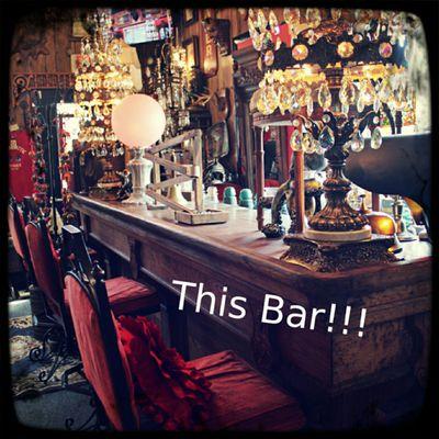 Wooden bar and bar stools where oddities are displayed for sale