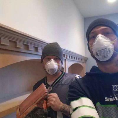 Owners Daniel Austin and Aaron Hawkins building a custom built-in book case.