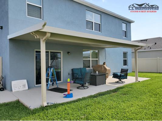 House with customized patio cover surrounded by grass landscape