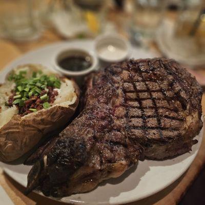 Gigantic prime rib with fully loaded potato