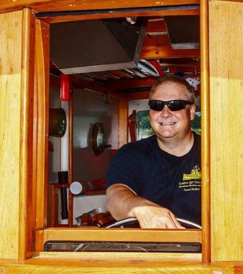 Captain Sheffield at the helm.