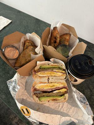 the sun setter bagel sandwich added ham, jerk chicken empanadas, chopped cheese empanadas, and coffee
