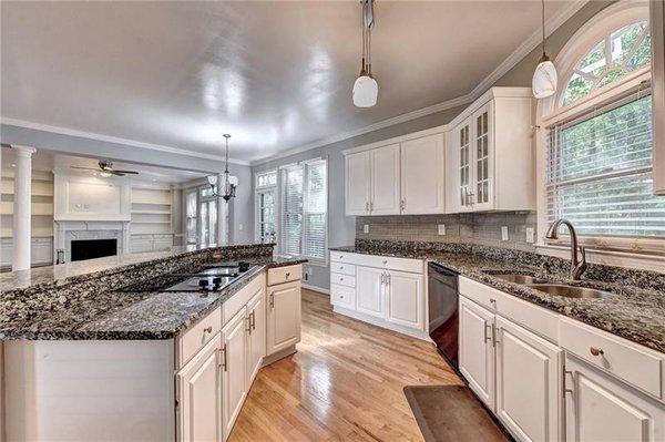 What do you think about this mostly white ally kitchen with fireplace in front?