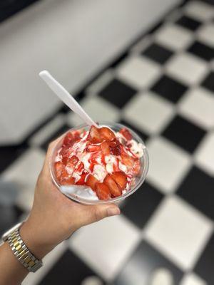 Strawberry cheesecake ice cream with sliced strawberries, strawberry sauce & whipped cream.