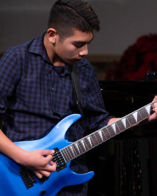 Guitar student performing at recital