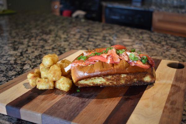 Our delicious lobster roll. Knuckle and claw lobster meat with garlic mayo, drawn butter, lettuce, and scallions