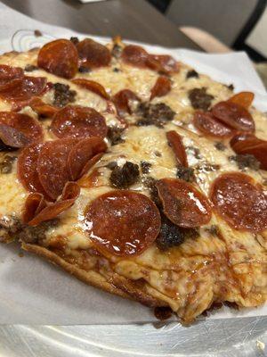 Pizza with pepperoni and ground beef