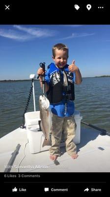 Gavin (5 years old) with his first redfish caught on our charter!