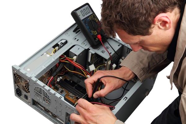 Computer Repair Technician Diagnosing a Desktop Computer