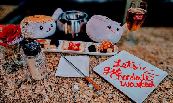 Food display, containing chocolates, garlic and wine, the pot itself and stuffies.