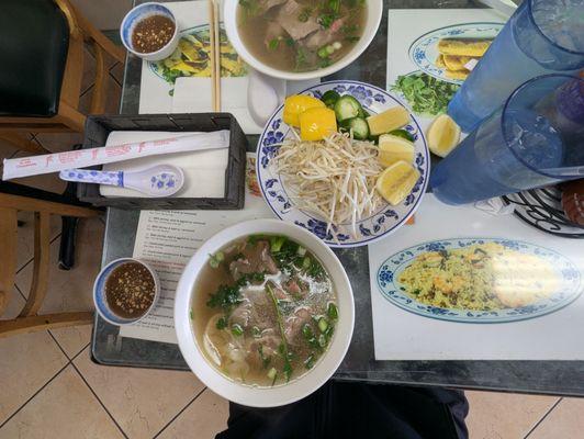 Pho with bean sprouts, jalapenos and lemon wedges served on the side
