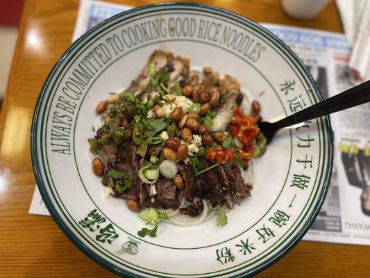 Crispy pork and beef rib meat with rice noodles. Added spicy red and a green chili sauce. Both were delicious.