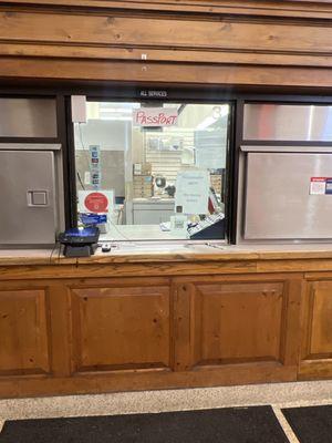 Empty passport window. Employees just walked by ignoring people asking questions through the window.