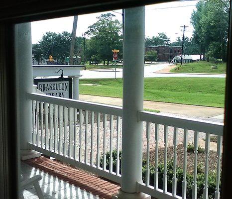 Braselton Library's porch rocking chair view. Grab a good book, I'll read with you.