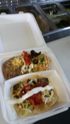 Two taco plate with fresh hand mashed beans made daily, fresh mexican rice made with locally sourced ingredients and your choice of meats.