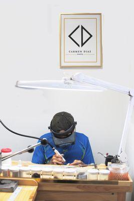 Jeweler working on a custom piece at Carmen Diaz Jewelry Studio