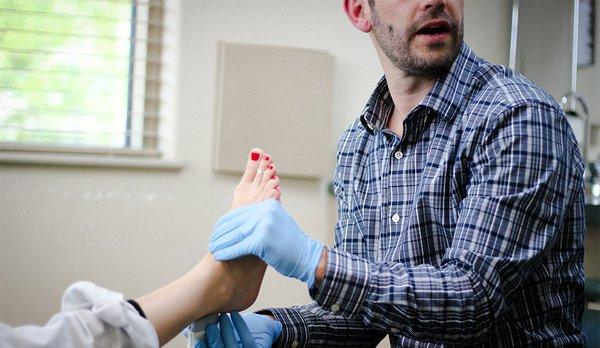 Landon Cameron, DPM working with a patient