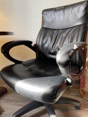 A filthy, torn chair in the room.