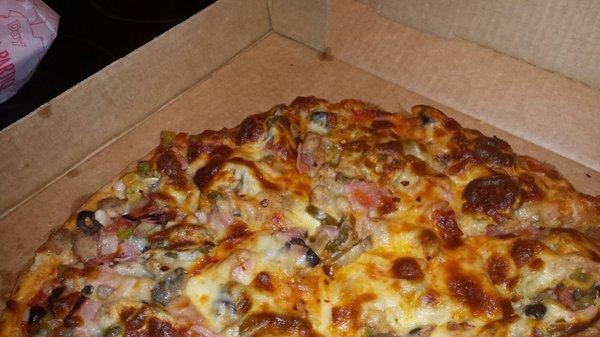 Supreme pizza with jalapeños in the box. Yum!