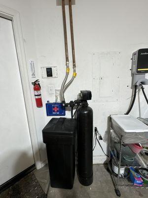 Water softener with mineral tank and brine tank and custom loop.