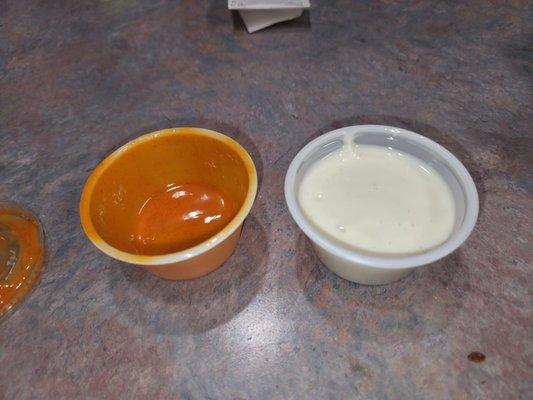 Here are the rationing tubs of blue cheese and buffalo mild sauce