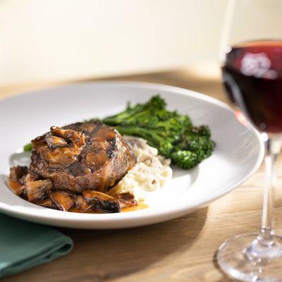 Wood-Grilled Filet Mignon served with broccolini, Yukon mash, red wine and mushroom sauce.