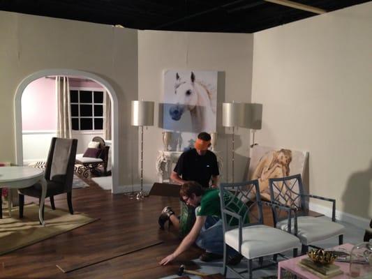 Students trying to fix the bubbling poorly made flats & covering the awful floor with laminate faux wood. LAUREN ADEL KLICH