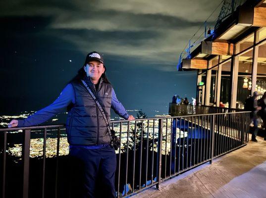 With my Son on the top of the mountain with a beautiful view and restaurant