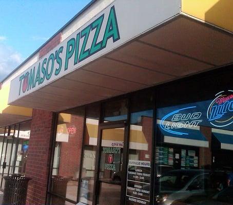 Storefront is located in a strip mall near the city square.
