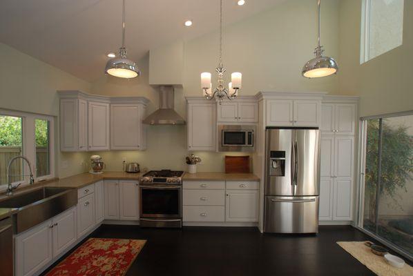 Complete kitchen remodel with raised panel white cabinets, vaulted ceiling and added windows for light.