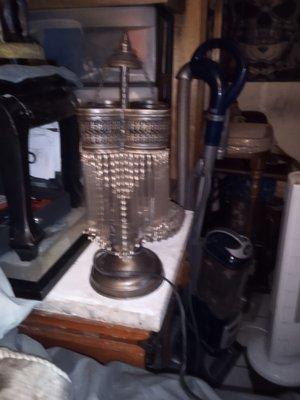 Bronze table lamp with beads and glass tubes hanging on it I want to know if it's worth anything