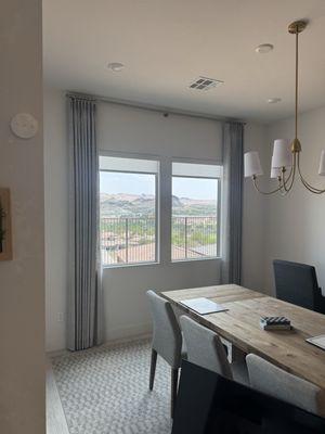 Decorative Curtain panels paired with light filtering Roller Shades.