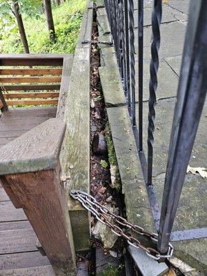 Chains holding retaining wall to patio railing